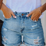High waisted distressed denim shorts with rolled hem in Blue, front view